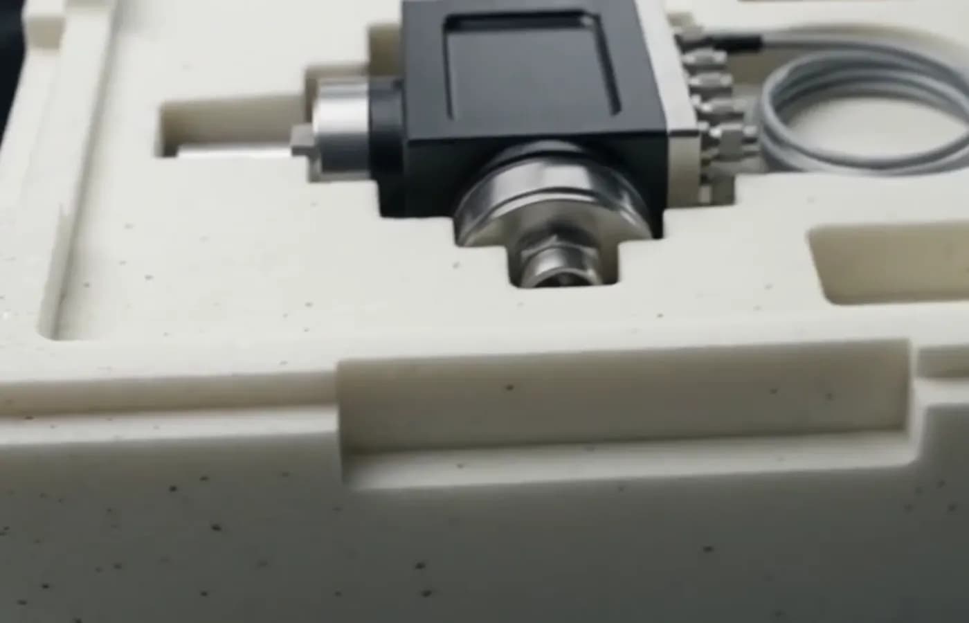 Precision-cut foam cavity shaped around an industrial component